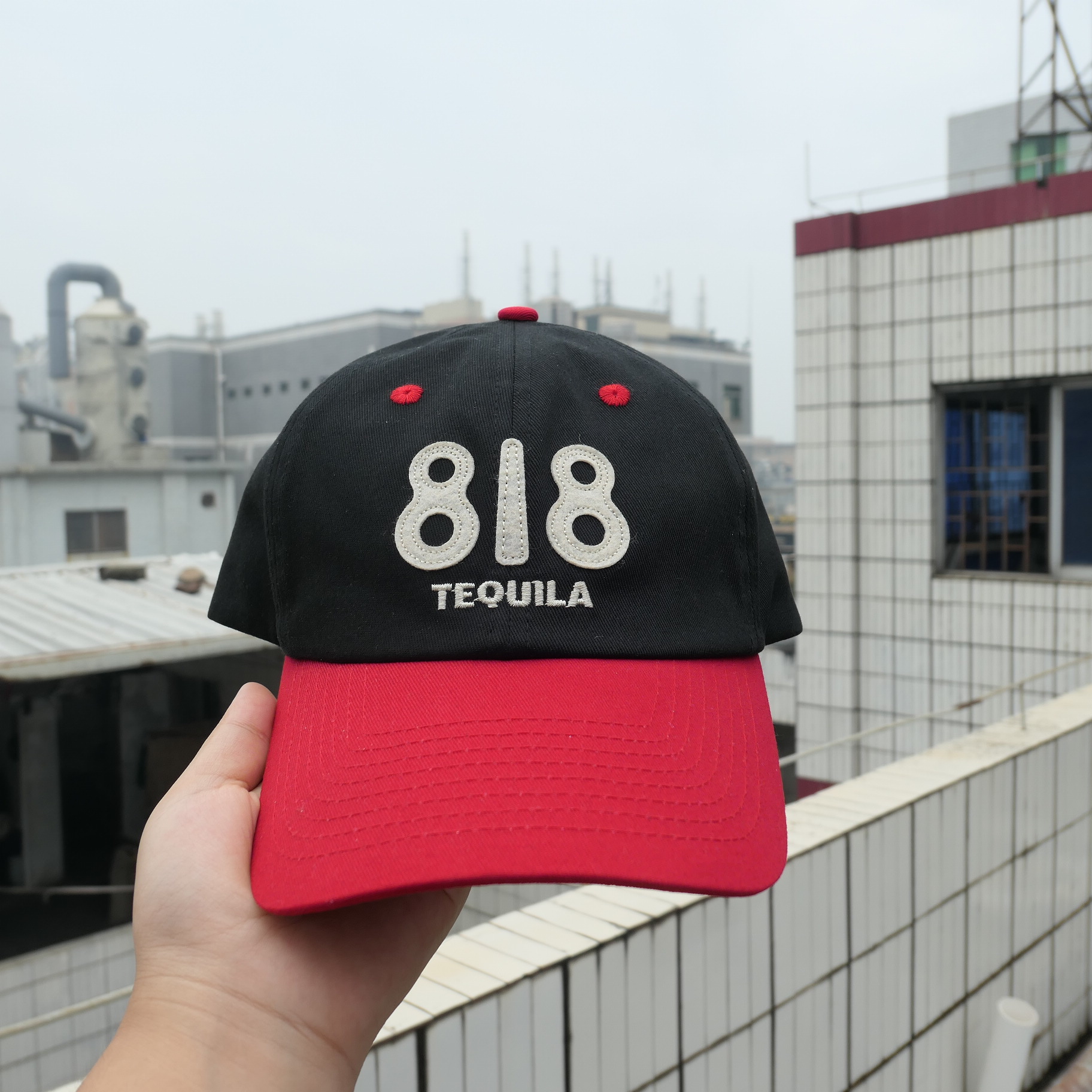 Black and red 818 Tequila sample with cream felt lettering