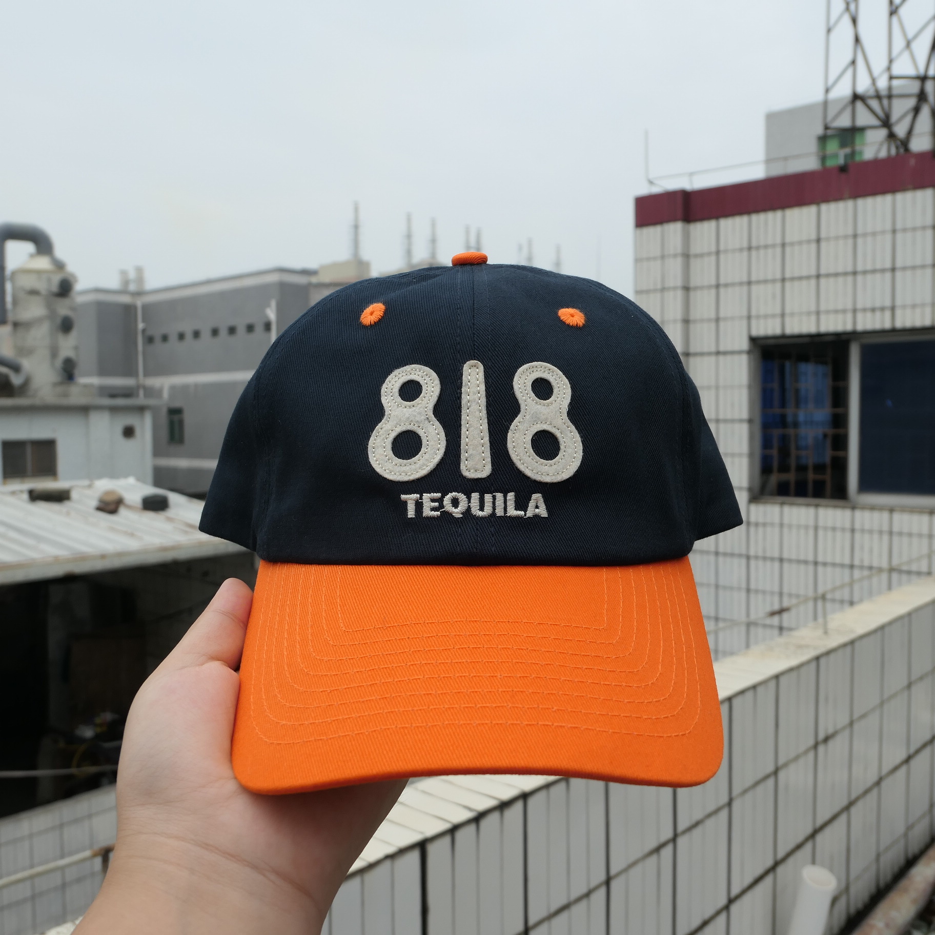Navy and orange 818 Tequila sample with cream lettering