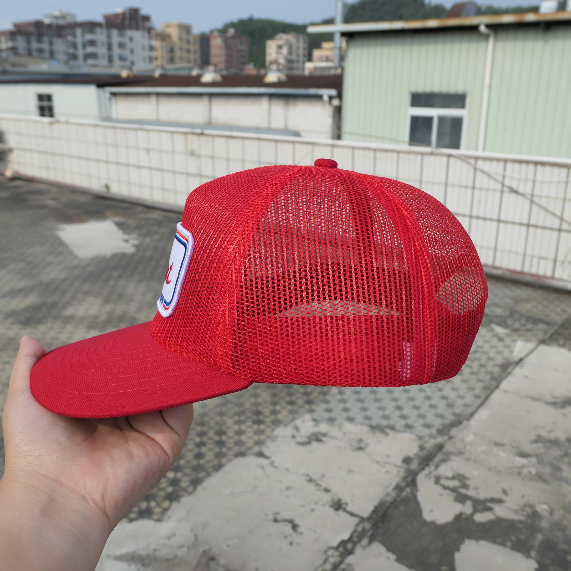Side view of the red Scout Motors mesh trucker