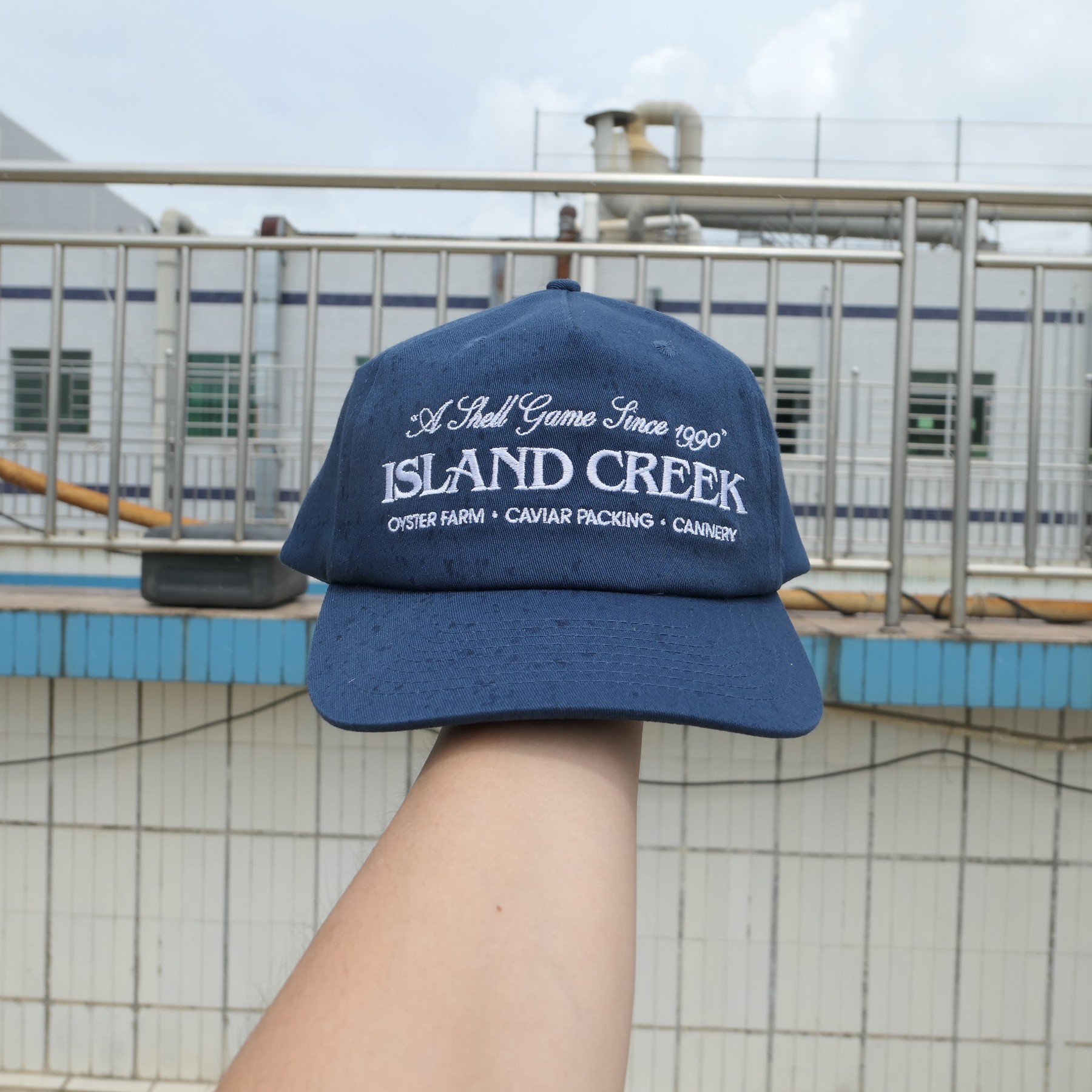 Navy Island Creek embroidered cotton cap photographed as a physical sample