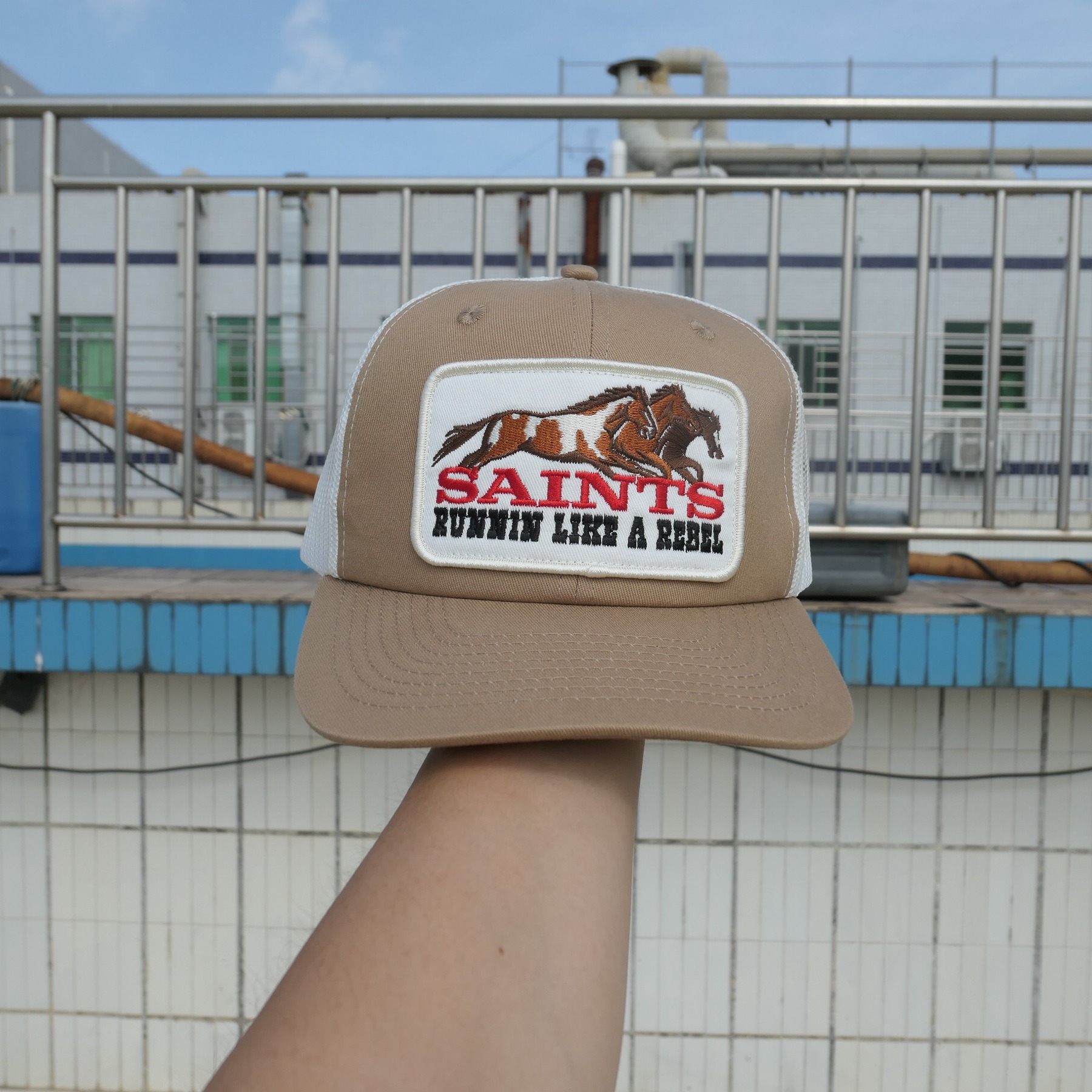 Brown and cream Saints Western sample cap with horses patch