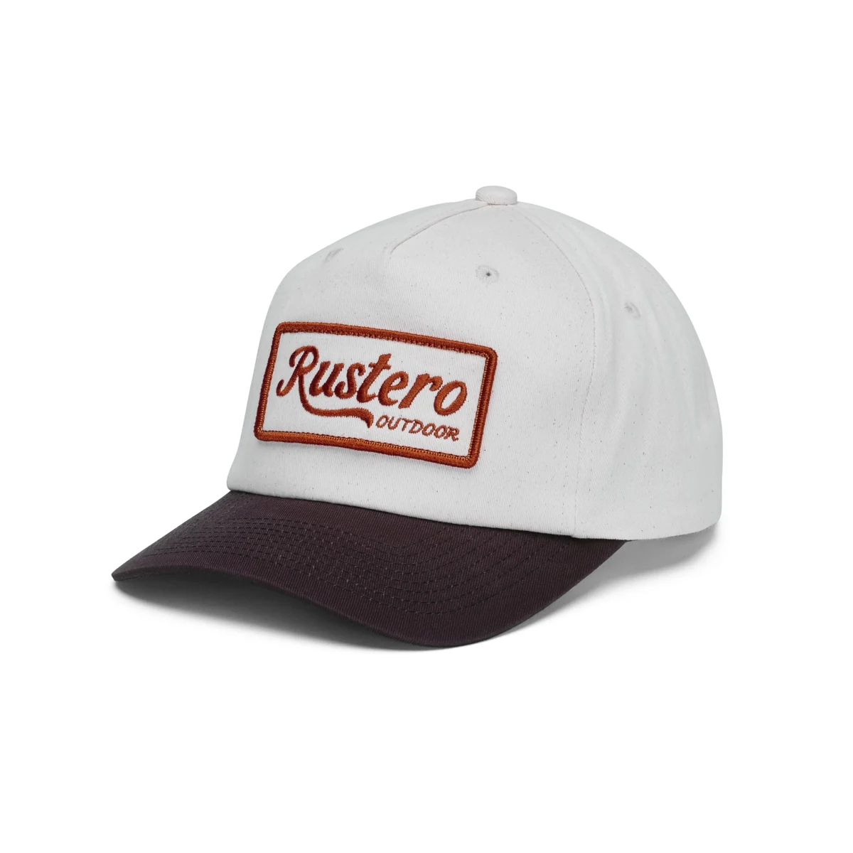 Cream Rustero cap with a dark brim and rectangular embroidered patch