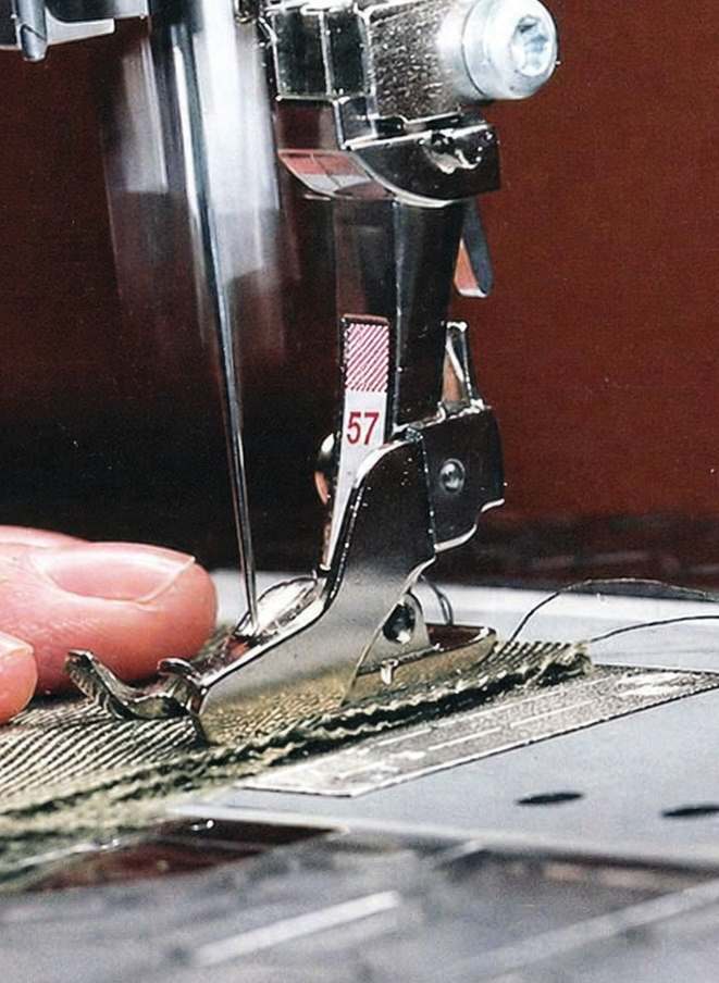A close-up of headwear being sewn, showing fabric and stitching