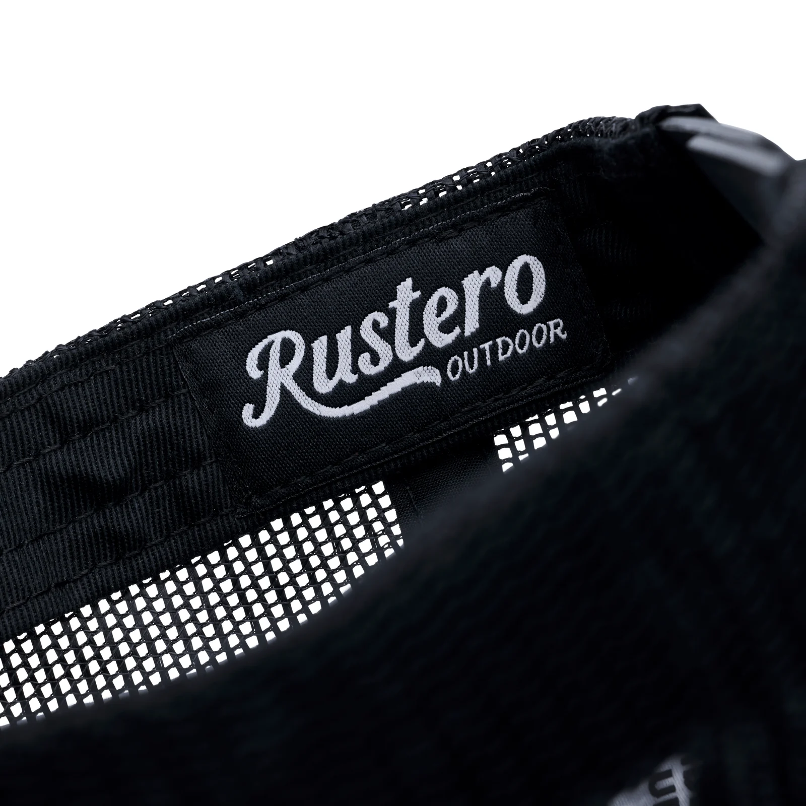 Rustero Outdoor woven label sewn into a black mesh cap sweatband