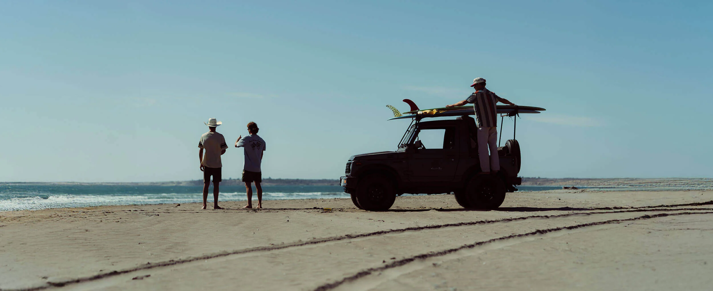 Seager Spring 2026 campaign with friends, surfboards and a truck on the beach